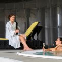 Two women enjoy a luxurious poolside moment with champagne, embodying relaxation and leisure.
